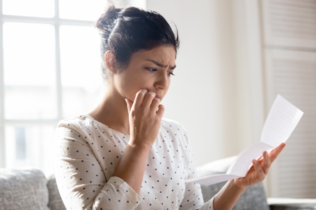 worried woman reading a letter
